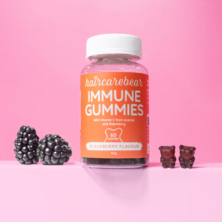 Haircarebear Immune Gummies pack  with two gummies on one side and two blackberries on the other side.