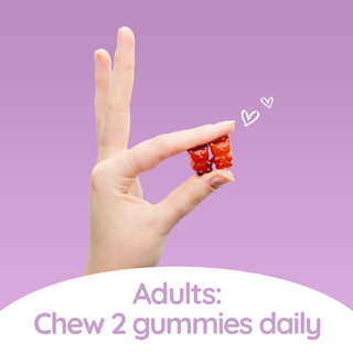A person is holding two red Haircarebear Magnesium Gummies with two fingers, with the text: 'Adults: chew two gummies daily.